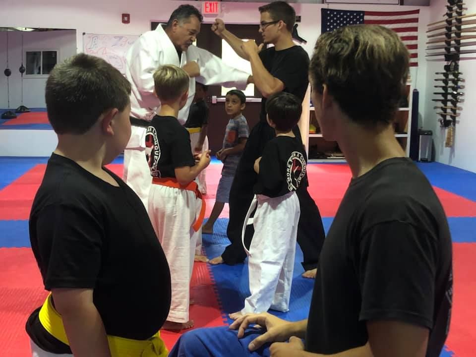 Newly earned belts tied on after a rank test