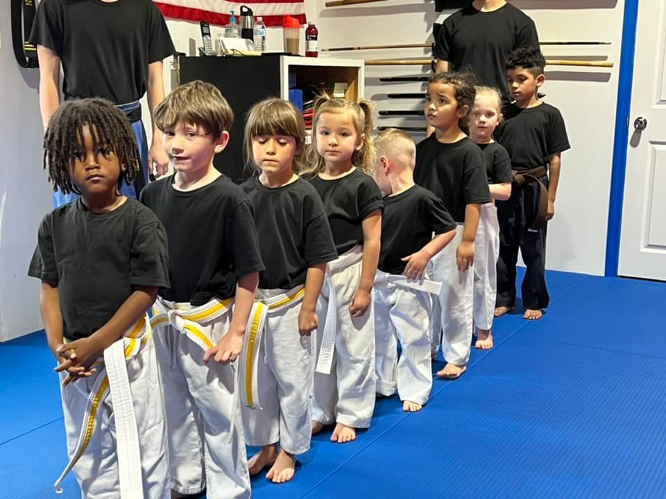 Little Warriors students lined up in uniform for a preschool martial arts class