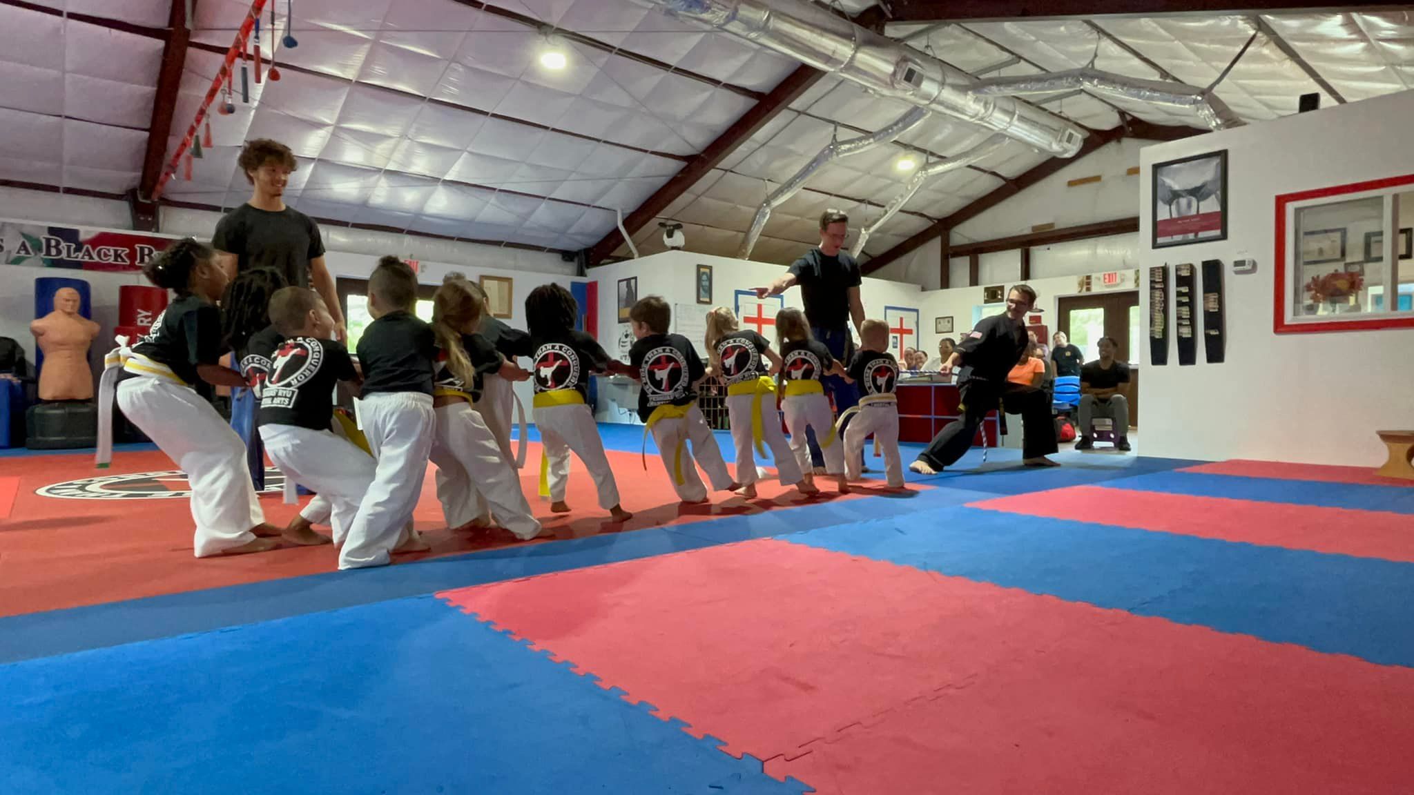 Little Warriors playing an active game on the dojo mat