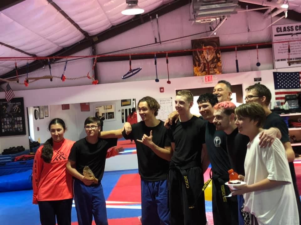 Teenagers training alongside adults in class