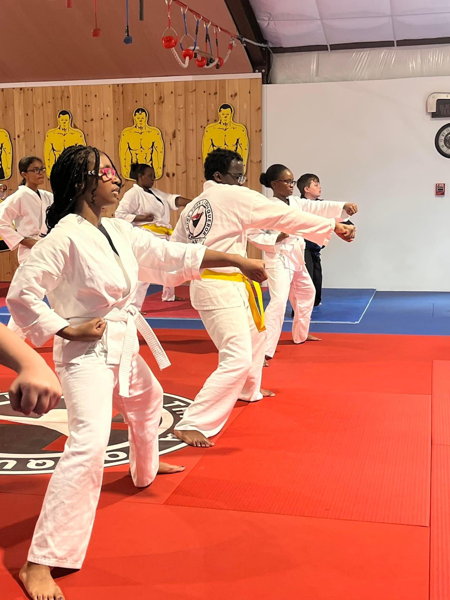 Teens and adults training together in a martial arts and fitness class